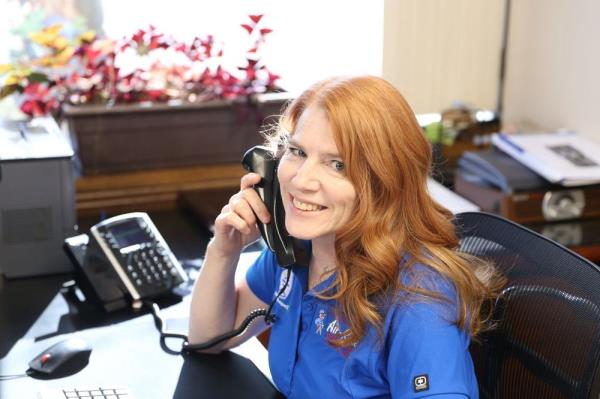 Tess from Air-Rite answering the phone at her desk