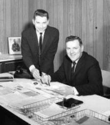 Air-Rite's founders reviewing plans at a desk in the 1950s