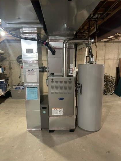 Completed Air-Rite Carrier furnace installation with new ductwork and venting